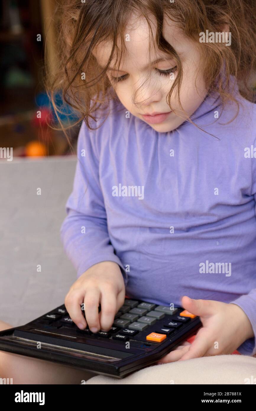 Little kid girl with a calculator in hands Stock Photo Alamy