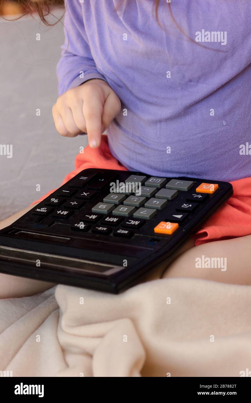 Little kid girl with a calculator in hands Stock Photo Alamy