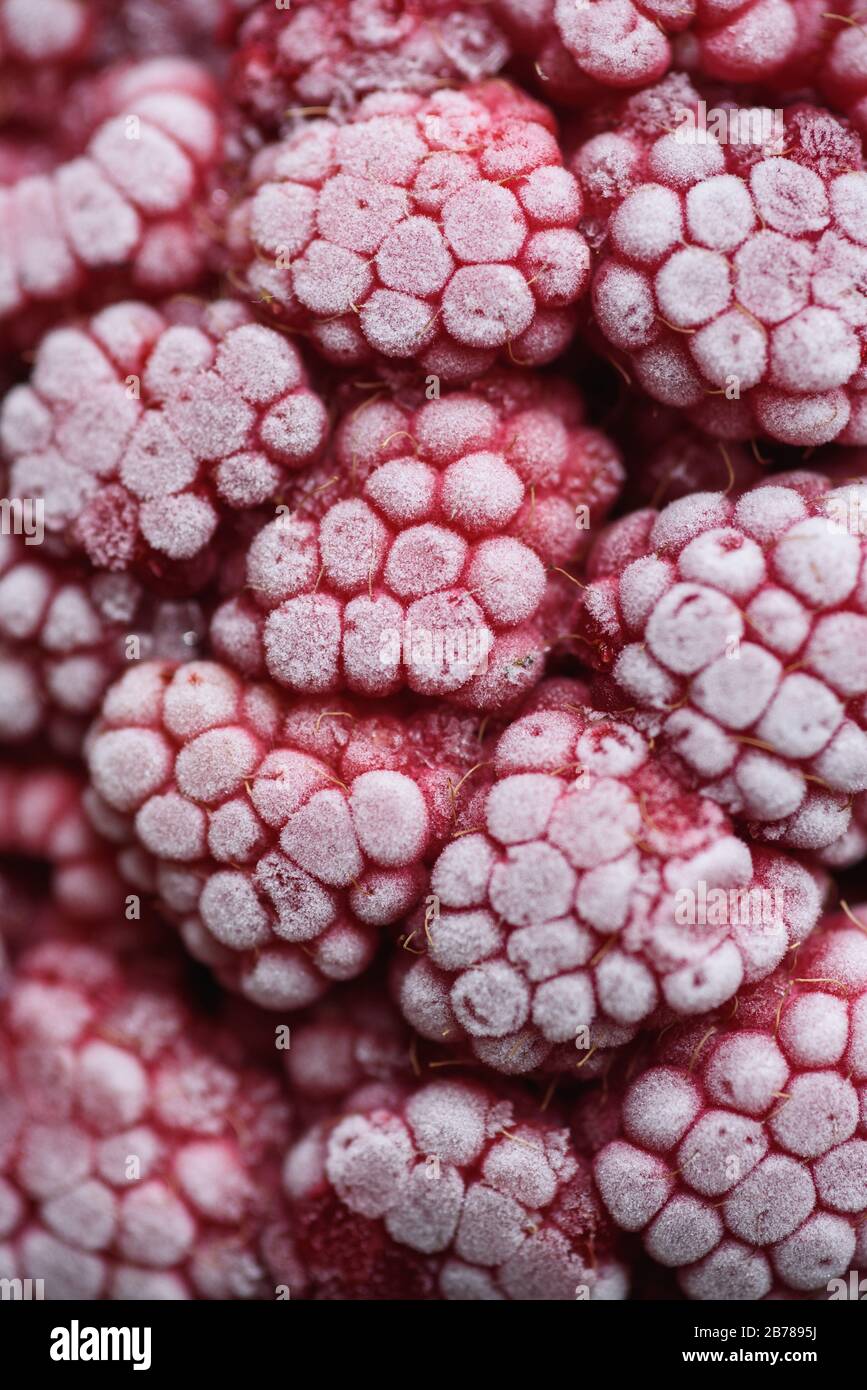 Food background. Freshly frozen raspberries, turned into a juicy piece of ice during freezing. Stock Photo