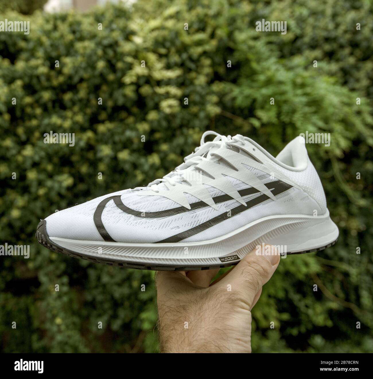 Paris, France - Sep 23, 2019: POV man hand demonstrating against green  background professional running shoe manufactured by Nike model Zoom Rival  Fly Stock Photo - Alamy