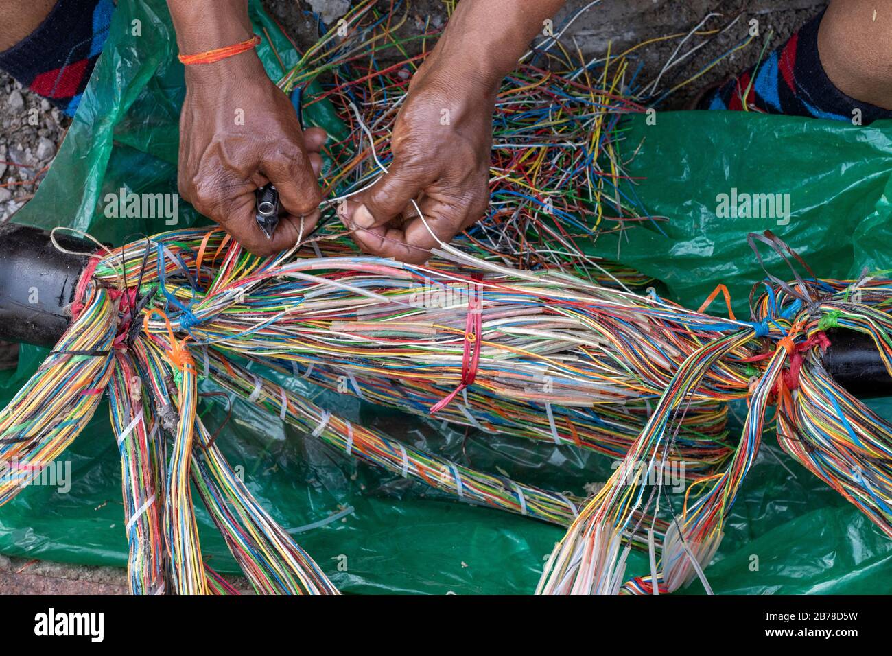 Technician repairing an underground telephone line multicolored wires Stock Photo