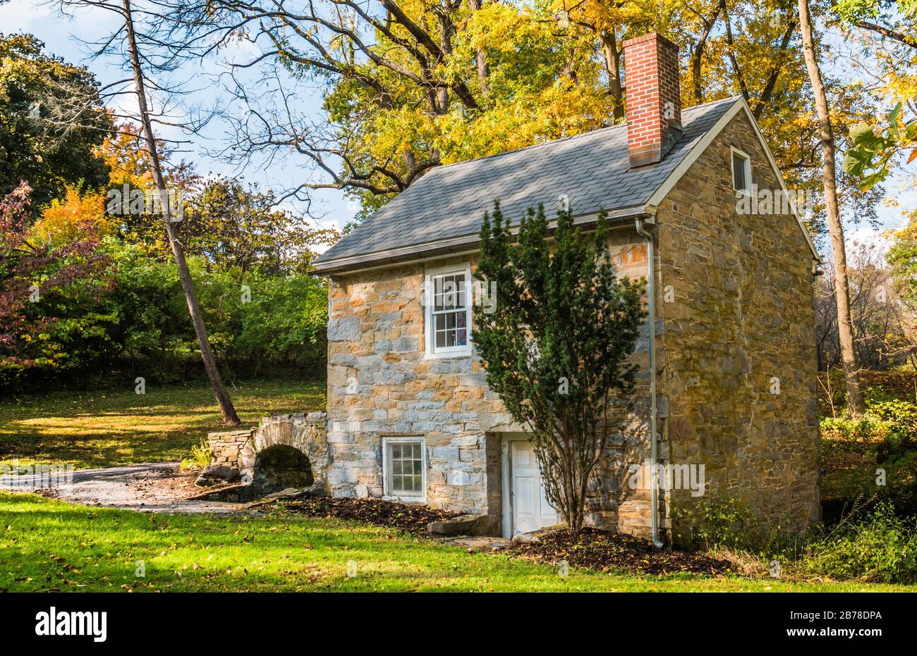 Small, old stone building amid colorful fall foliage in Wyomissing Park