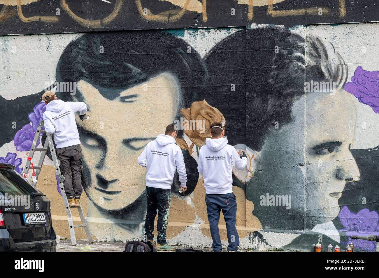 Munich, Germany. 14th Mar, 2020. Three men are working on a graffito with the portrait of Hans Scholl from the resistance group Weiße Rose in the Third Reich, which the Verein zur Förderung urbaner Kunst has invited to realize. The conceptual artwork is being created on the grounds of the slaughterhouse. Credit: Peter Kneffel/dpa/Alamy Live News Stock Photo