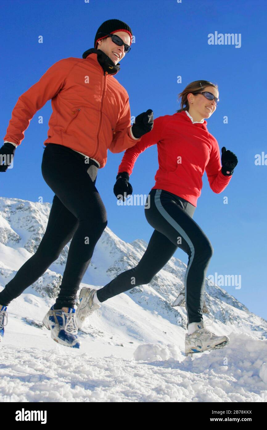 Mann und Frau joggen im Winter Stock Photo