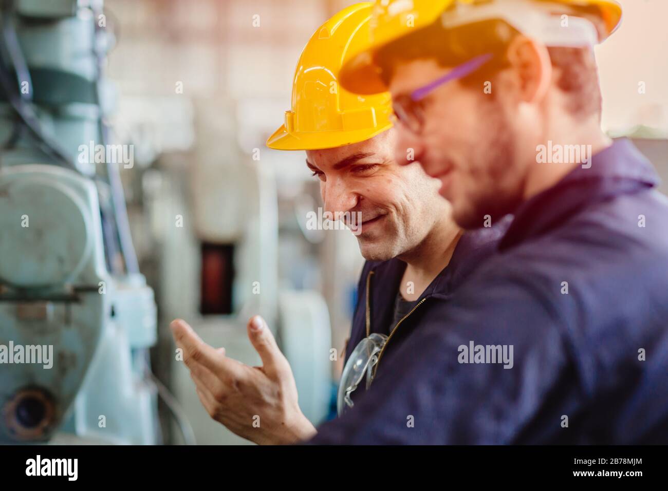 happy worker, smiling industrial technician engineer enjoy working together with coworker. Stock Photo