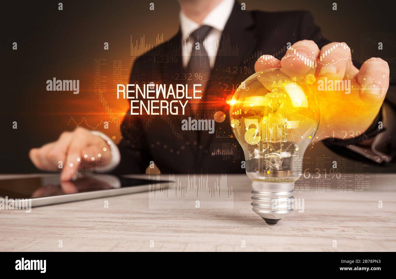Businessman Holding Lightbulb With Renewable Energy Inscription