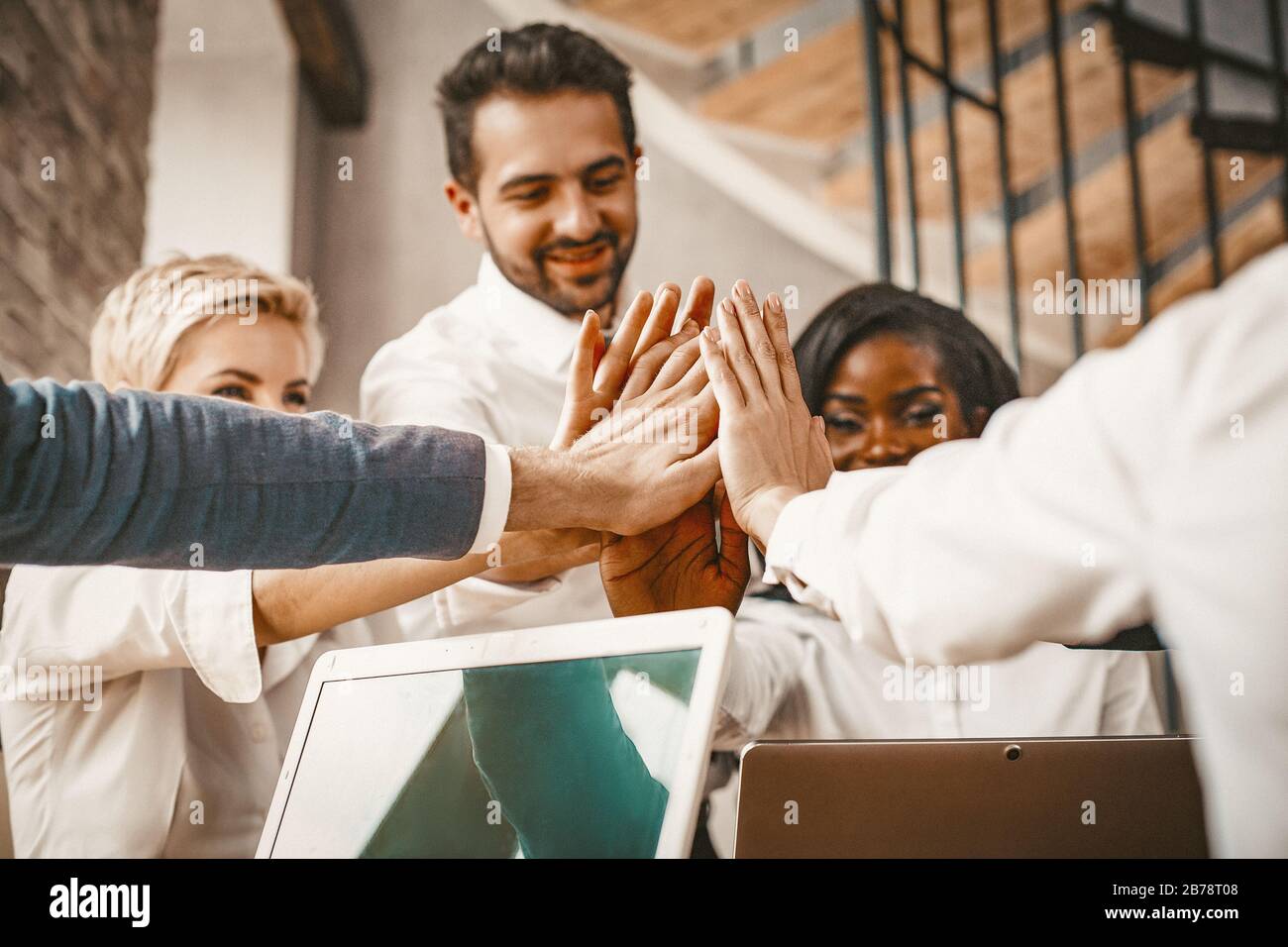 High Five Of Multi Ethnic Business Team In Office Stock Photo - Alamy