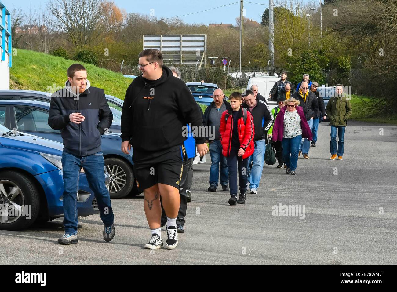 Weymouth, Dorset, UK.  14th March 2020.  Fans arriving for the Weymouth FC v Slough Town Vanarama National League South match at the Bob Lucas Stadium ahead of the 3pm kickoff.  Most National league football is still playing this weekend despite the Premier League and EFL shutting down due to the coronavirus.  Picture Credit: Graham Hunt/Alamy Live News Stock Photo