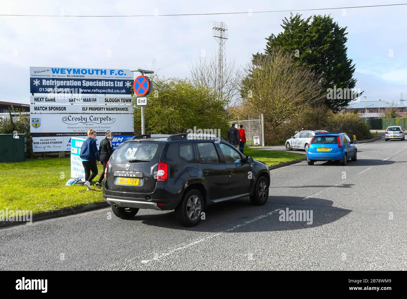 Weymouth, Dorset, UK.  14th March 2020.  Fans arriving for the Weymouth FC v Slough Town Vanarama National League South match at the Bob Lucas Stadium ahead of the 3pm kickoff.  Most National league football is still playing this weekend despite the Premier League and EFL shutting down due to the coronavirus.  Picture Credit: Graham Hunt/Alamy Live News Stock Photo