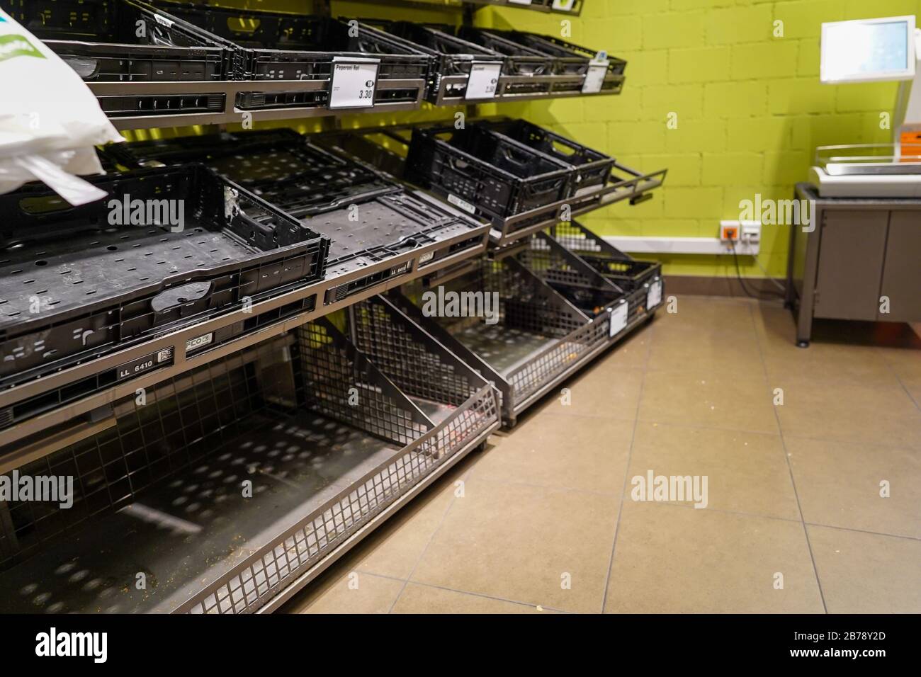View of empty fruit and vegetable shelves in a European supermarket after buying food supplies because of Covid-19 Stock Photo