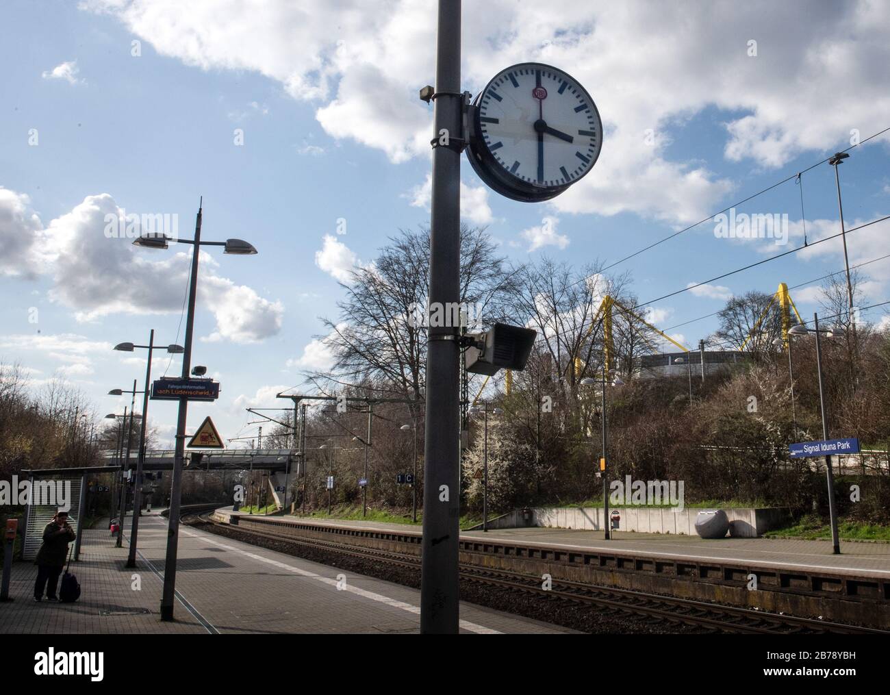 Dortmund, Germany. 14 March 2020, North Rhine-Westphalia, Dortmund: The clock at the almost deserted train station at Borussia Dortmund's stadium, Signal Iduna Park, shows 15:30. Normally, the derby between Dortmund and Schalke would have started at that time. The German Soccer League has temporarily suspended play in the Bundesliga and the 2nd League due to the coronavirus pandemic. The game day planned for this weekend will be postponed, the German Soccer League (DFL) announced on Friday. Photo: Bernd Thissen/dpa - IMPORTANT NOTE: In accordance with the regulations of the DFL Deutsche Fußbal Stock Photo