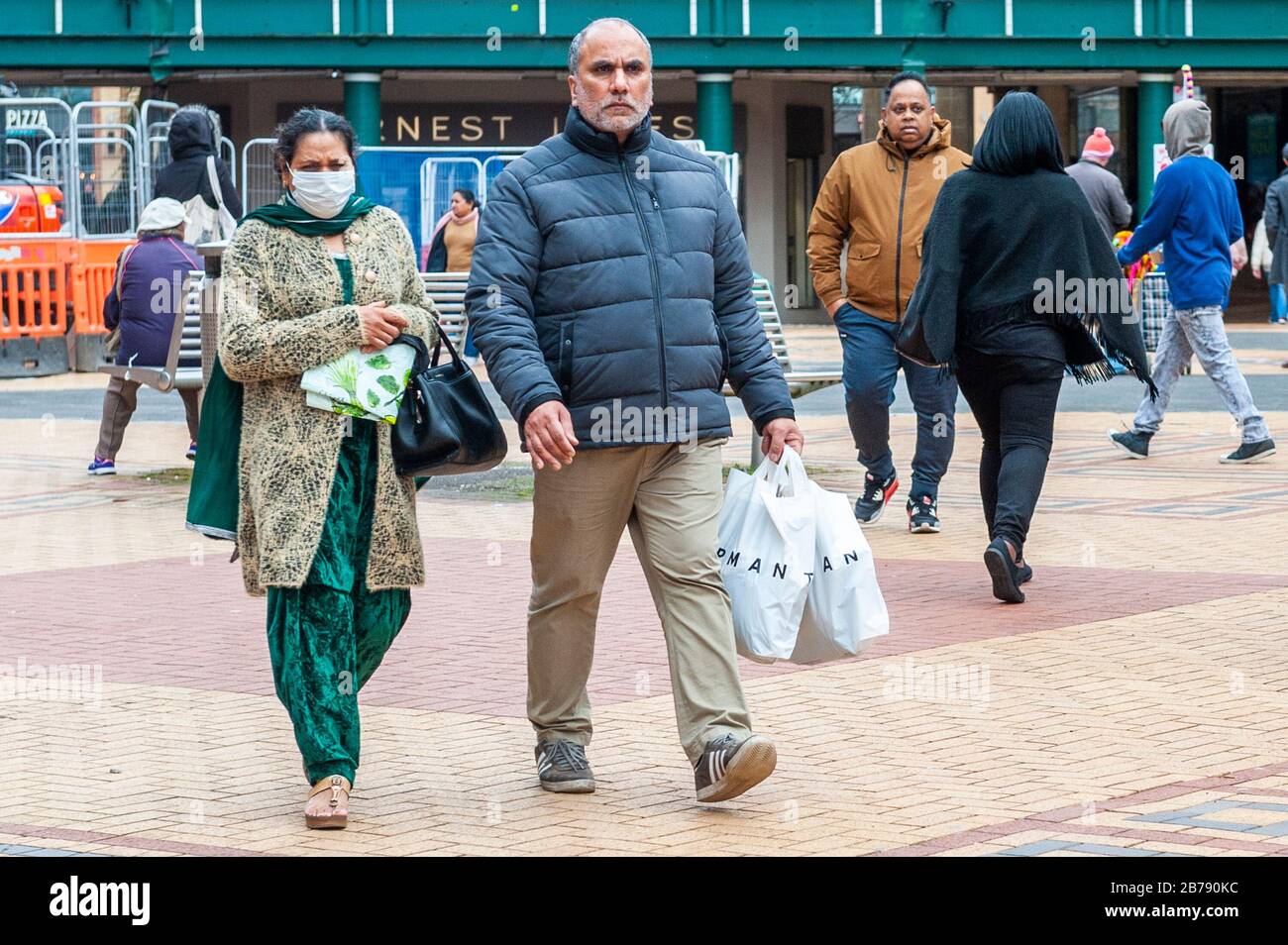 Coventry, West Midlands, UK. 14th Mar, 2020. The Coronavirus pandemic forced shoppers to wear protective masks in Coventry city centre this morning. Credit: Andy Gibson/Alamy Live News Stock Photo