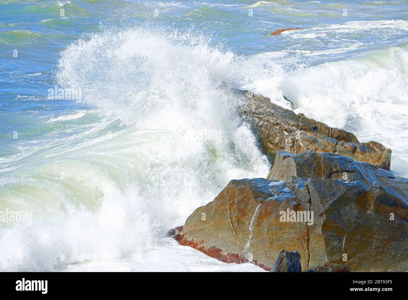 Sea waves are bouncing hard onto rocks near Tropea, Calabria, Italy. Stock Photo
