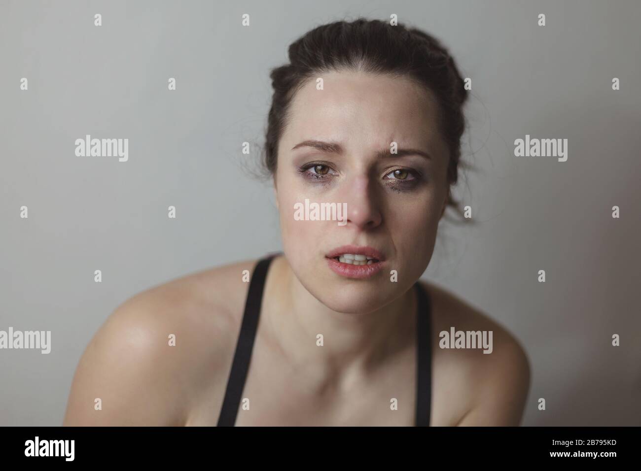 Young woman with her eyes red from crying and mascara smeared Stock