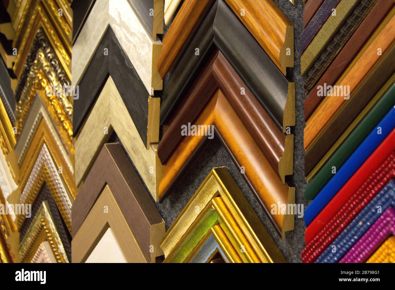 Craftsman working on frame in frame shop. Professional framer hand