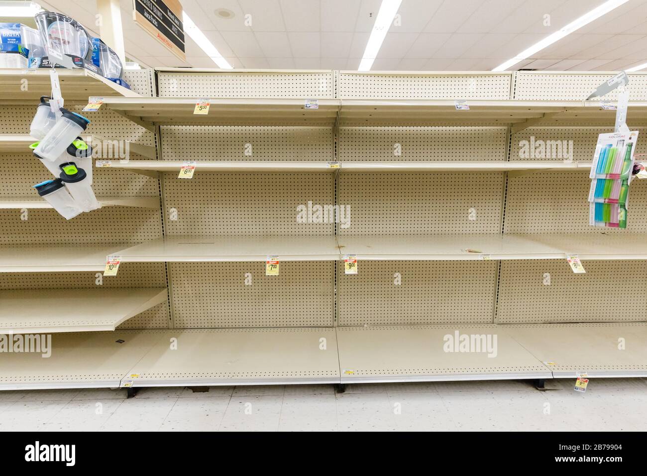Empty shelves in a supermarket grocery store in the bottled water aisle