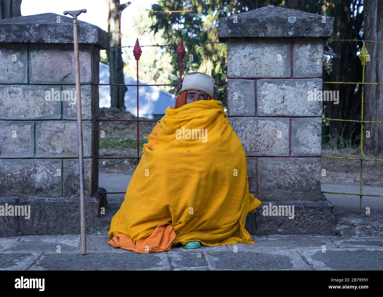 Priest covered in an yellow shawl in Entoto orthodox Maryam Church, Addis Ababa Region, Addis Ababa, Ethiopia Stock Photo