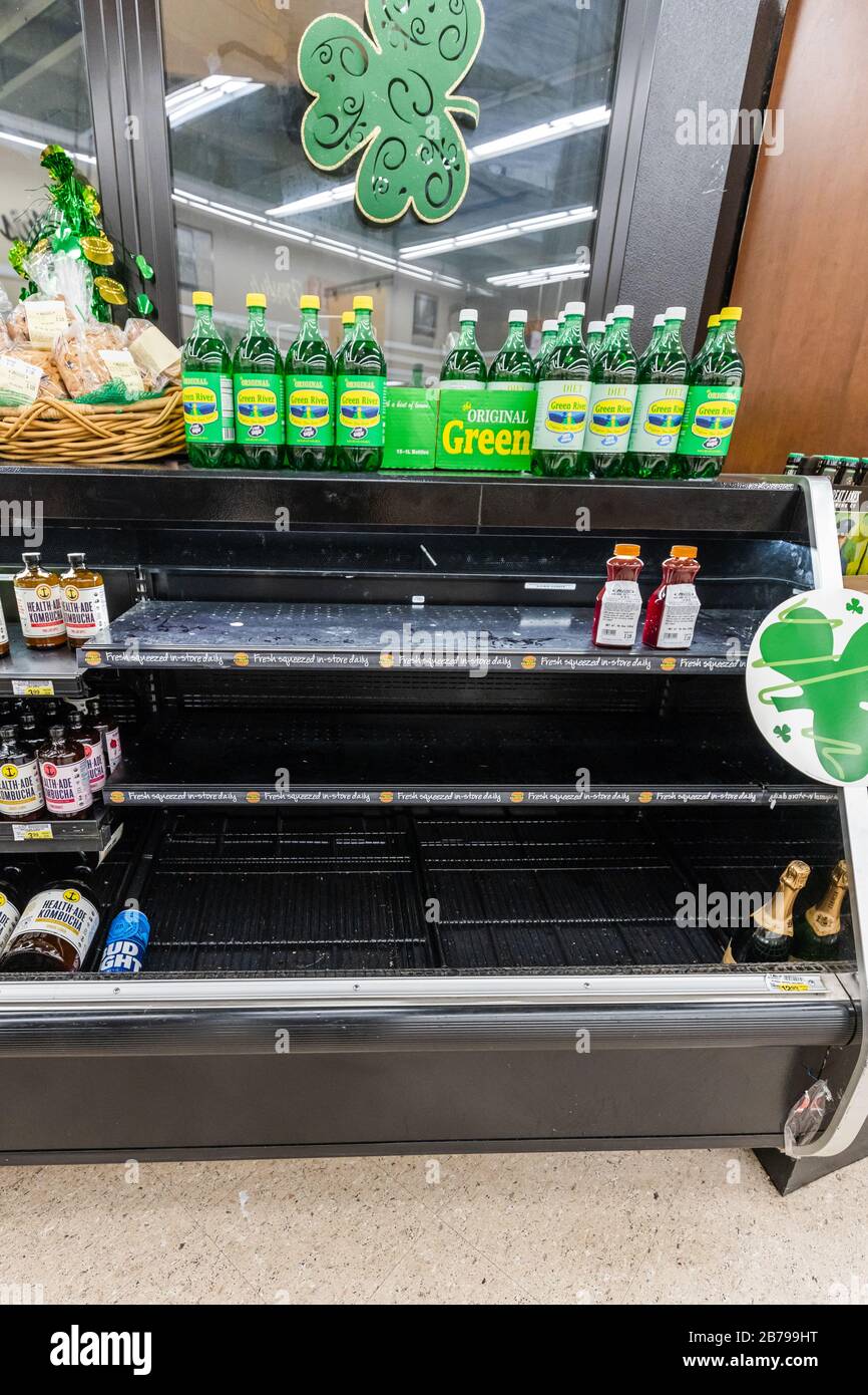 Nearly empty freezer aisle of a grocery store supermarket as coronavirus causes fear and panic for shoppers Stock Photo