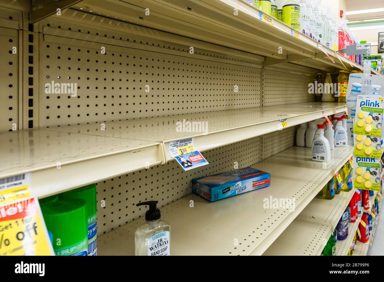 Nearly empty shelves in a supermarket grocery store in the tissue box aisle as coronavirus causes fear and panic Stock Photo