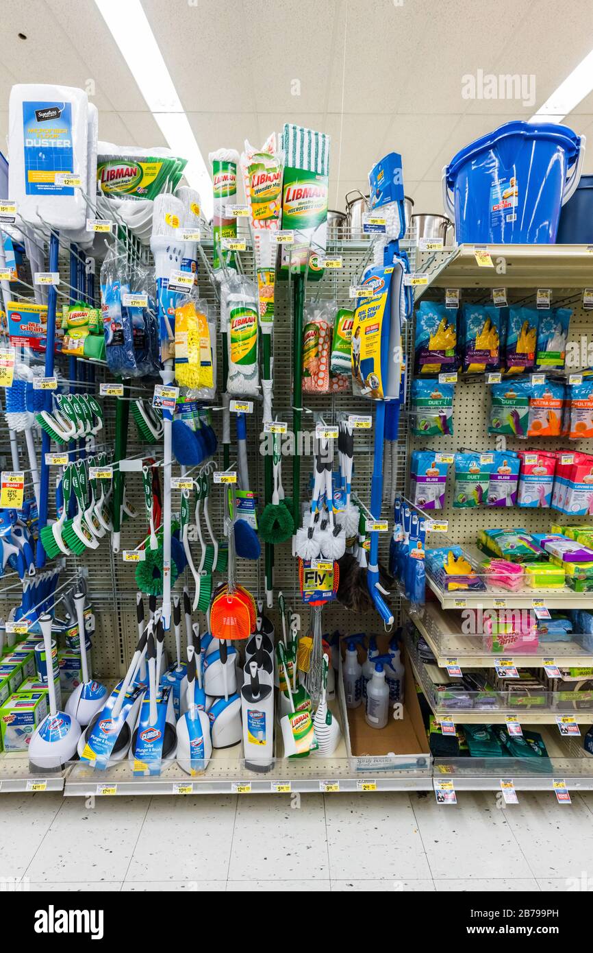 Completely stocked shelves of mops, brushes, and other cleaning