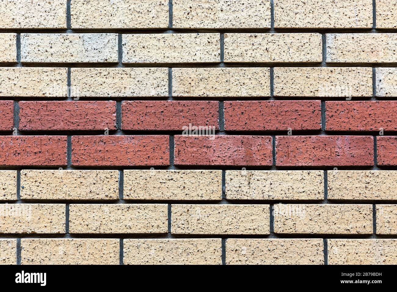 Red and beige painted brick wall background texture close up. Stock Photo