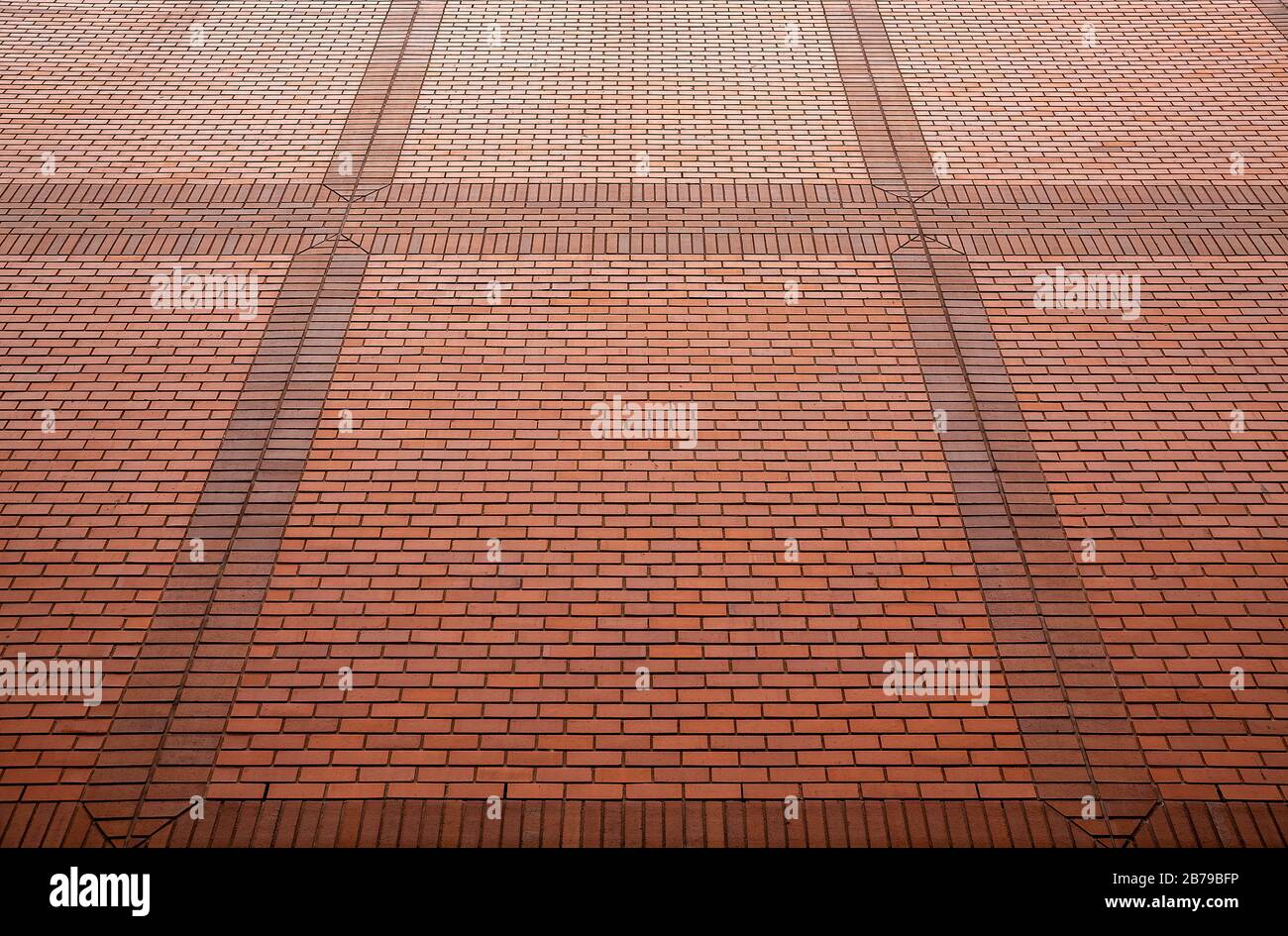 Red brick wall in perspective for background texture close-up. Stock Photo