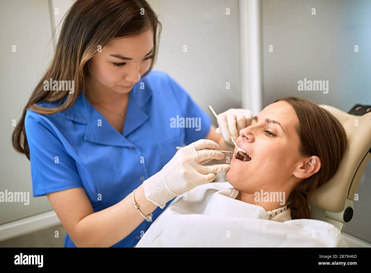 Young woman at dentist repairing the tooth Stock Photo
