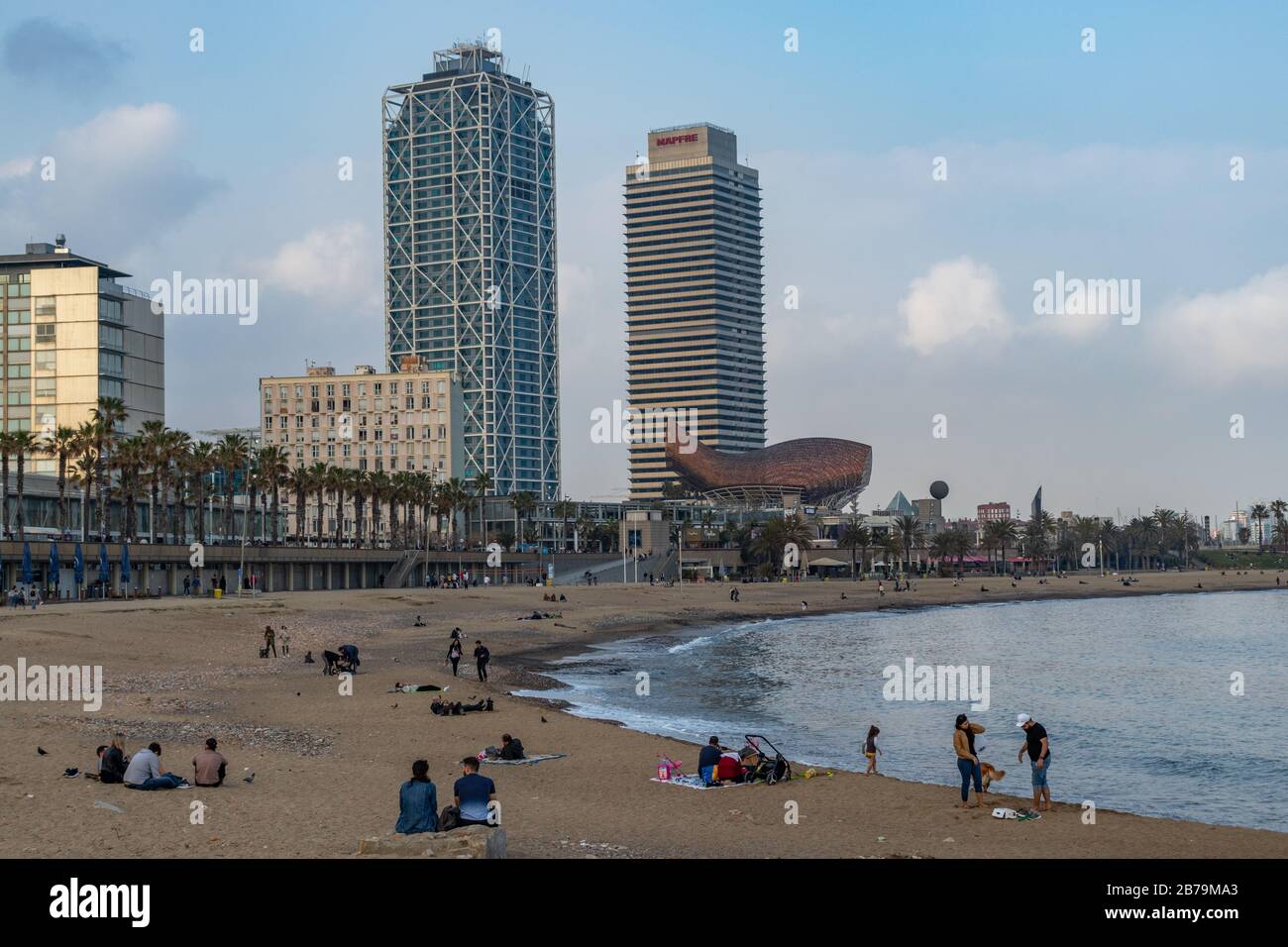 Barcelona, Spain. 14th March, 2020. Crowd sitting on Barcelona seaside on a cloudy saturday afternoon despite the Spanish government declared alert st Stock Photo