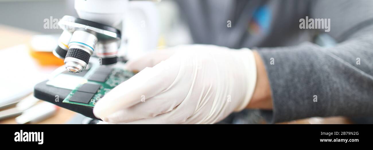 Man soldering using microscope Stock Photo Alamy