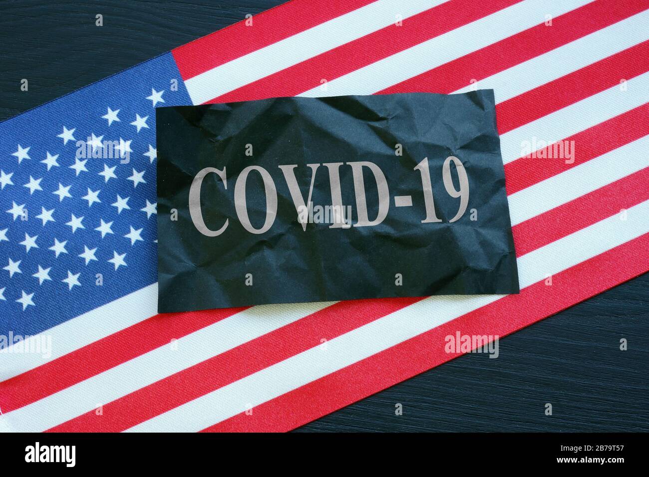 USA flag and covid-19 coronavirus sign as symbol of epidemic. Stock Photo