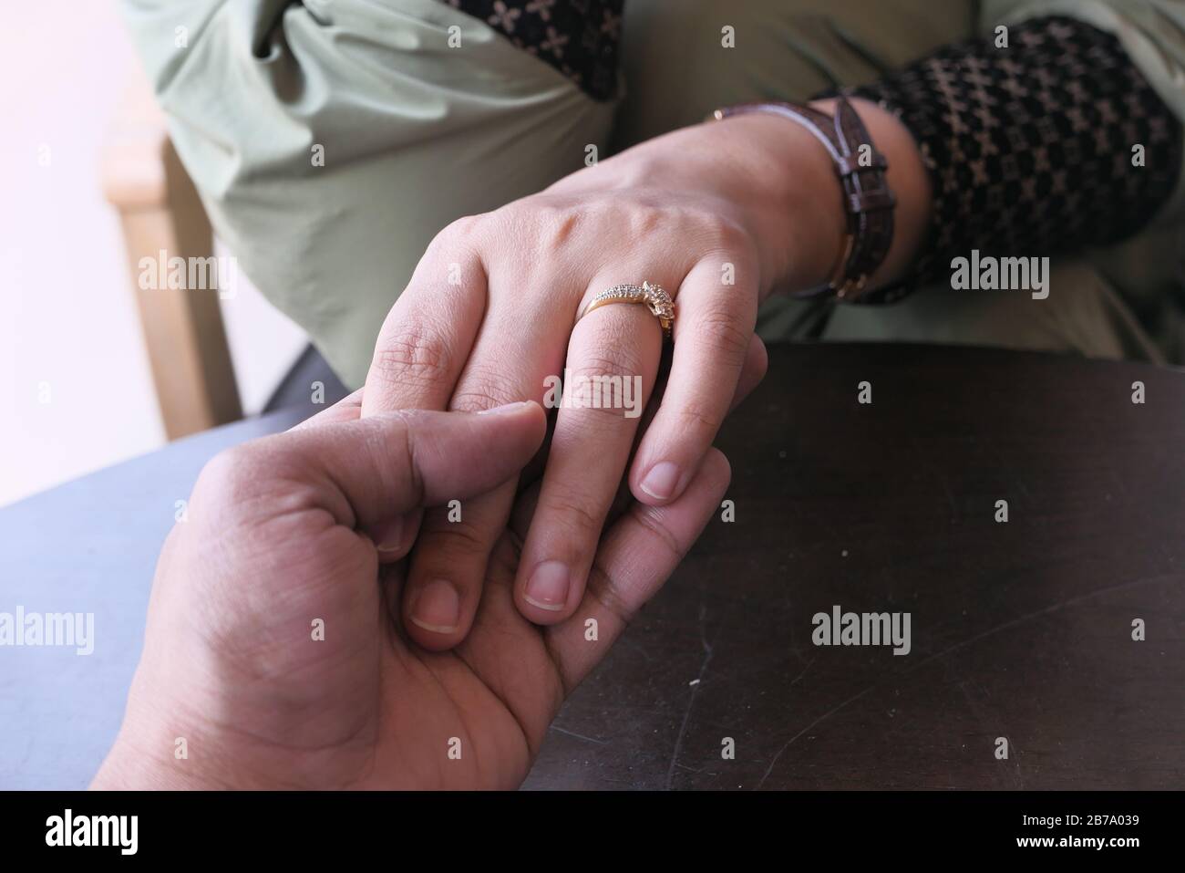 young couple holding hand each other, close up Stock Photo
