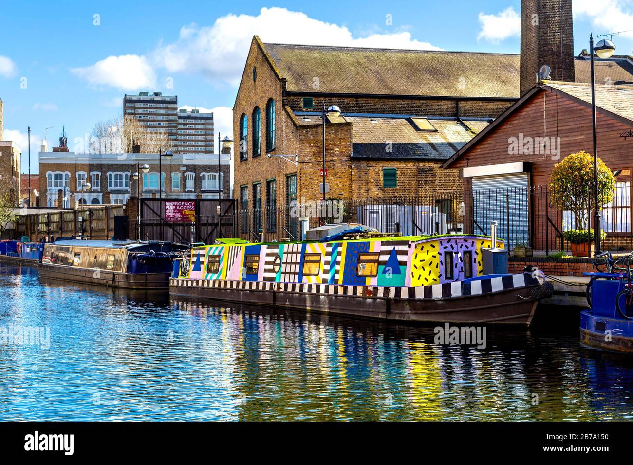 Houseboat painted in colourful graphic patterns mooring in Hertford Union Canal, London, UK Stock Photo