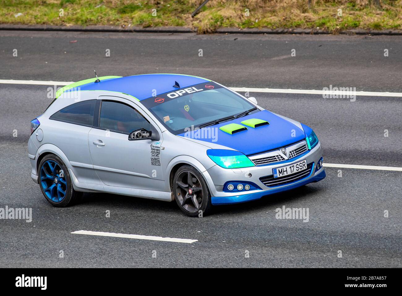 2013 Modified Blue grey Opel Astra OPC hatchback racing 2dr car; Vehicular traffic, transport, custommized modern vehicles, saloon family cars, vehicle on UK roads, motors, motoring on the M6 motorway Stock Photo