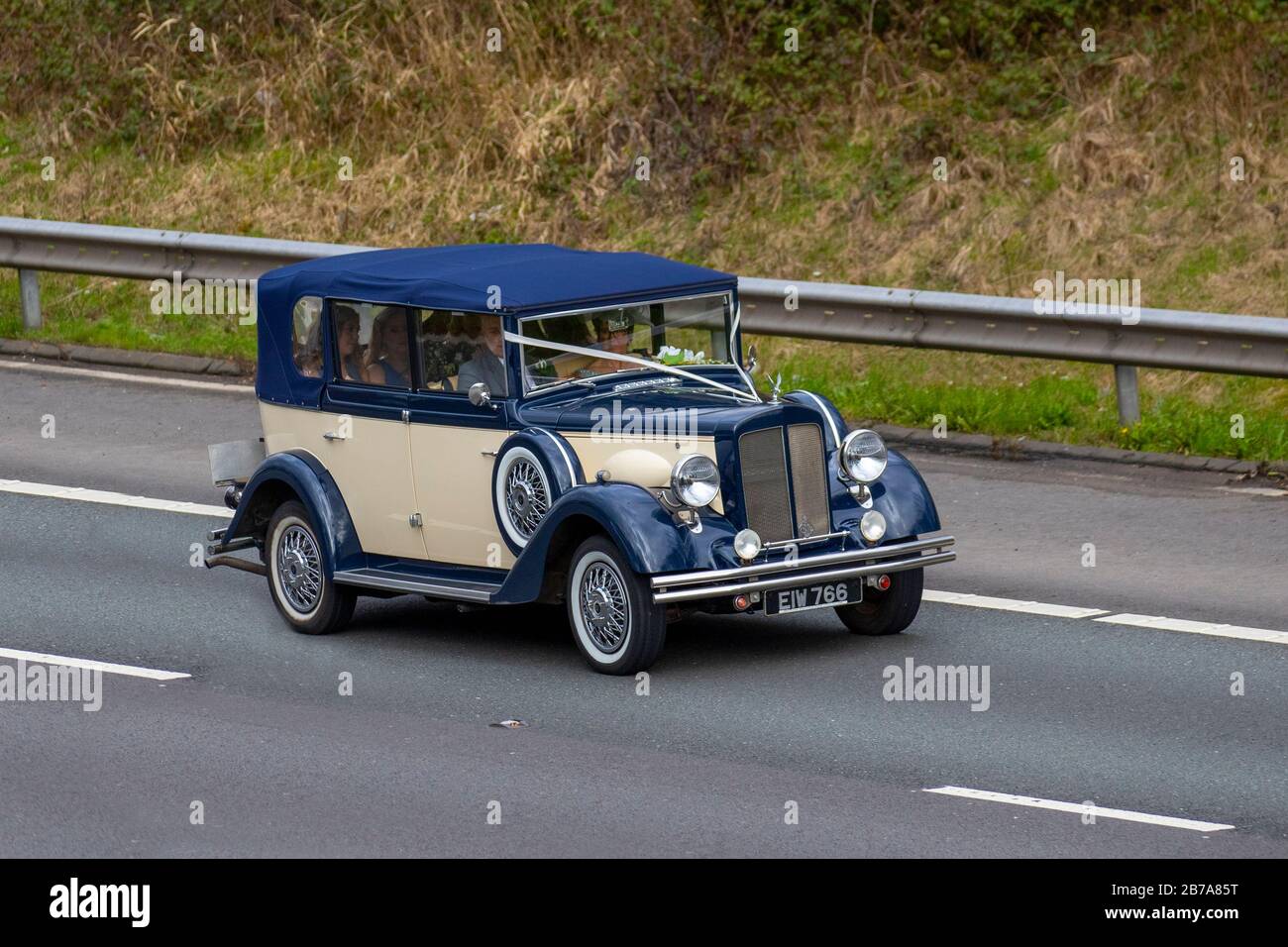 1990 90s blue cream Carbodies Taxi Hire CAR; Vehicular traffic, transport, modern vehicles, saloon cars, vehicle on UK roads, motors, motoring on the M6 motorway Stock Photo