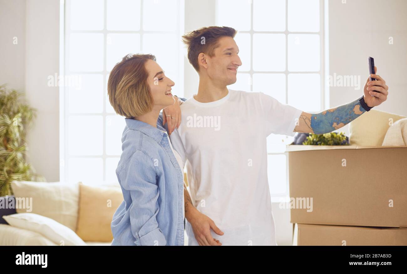 Happy smiling young couple showing a pair of keys of their new house ...