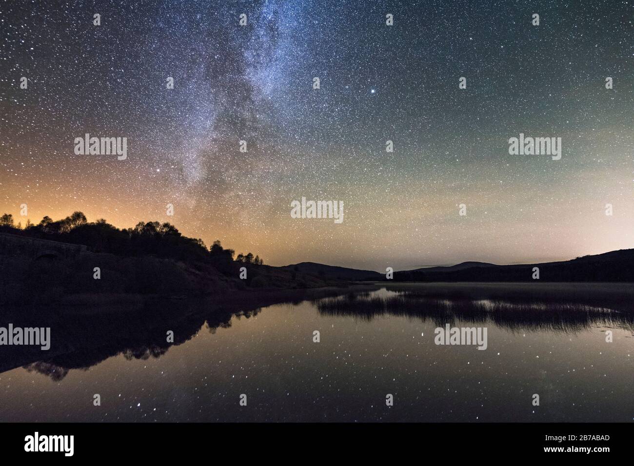 Milky Way and stars over Loch Stroan, Galloway Dark Sky Park, Galloway Forest, Dumfries & Galloway, Scotland Stock Photo