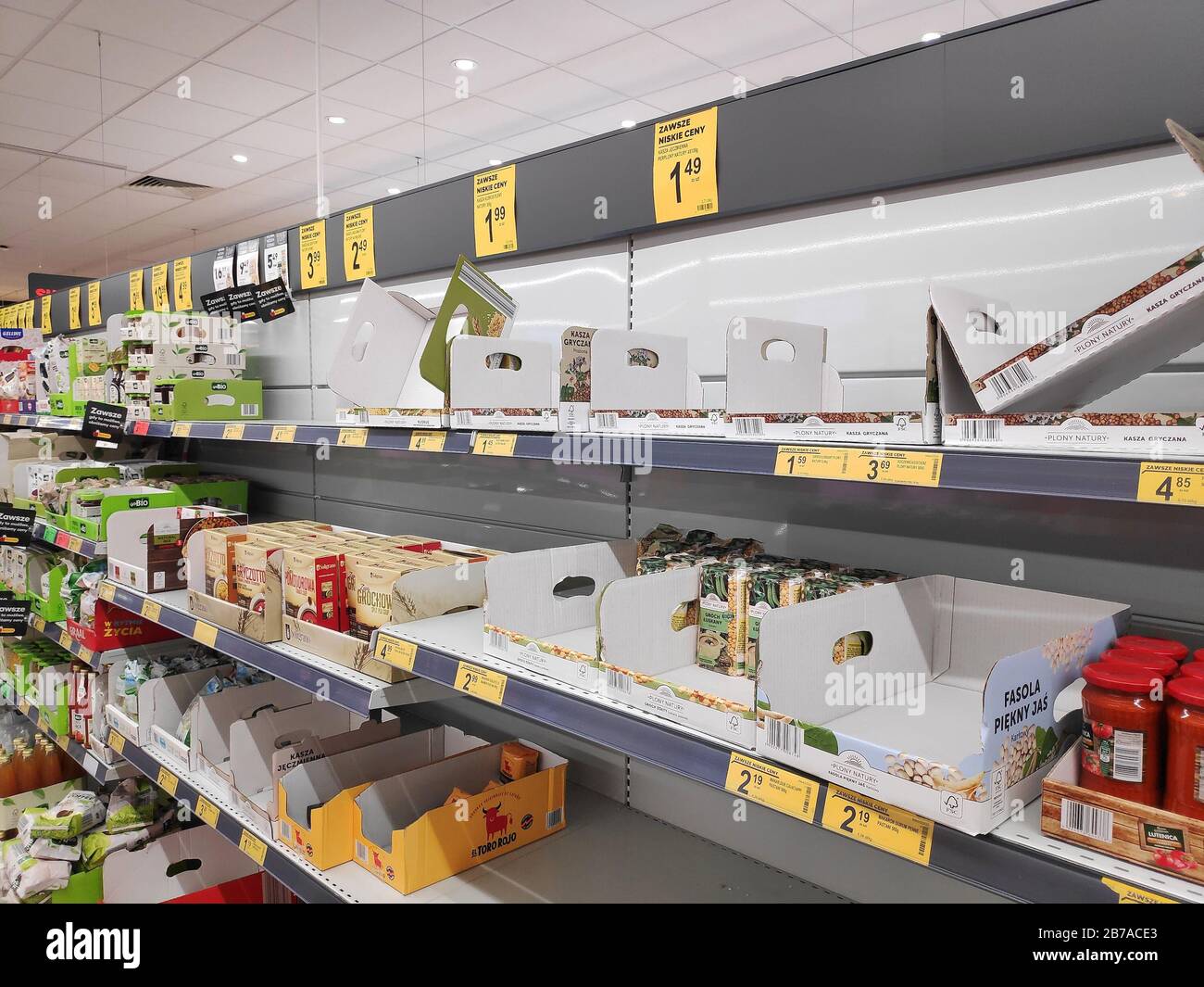 KATOWICE, POLAND - MARCH 14, 2020: Empty supermarket shelf in a grocery store in Poland. Local people stockpiled food in anticipation of Coronavirus ( Stock Photo
