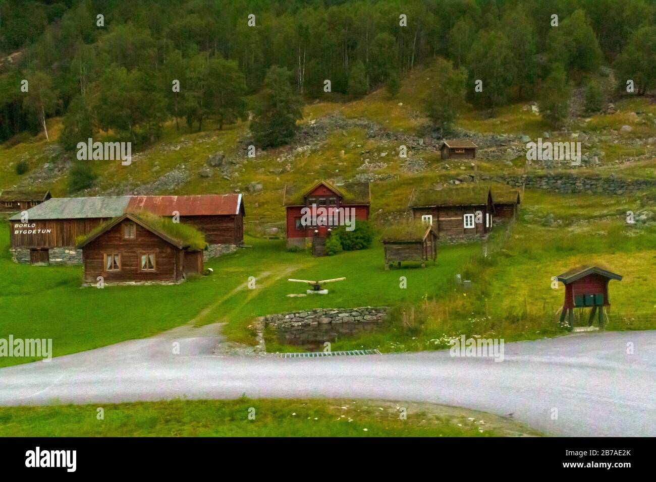 Traditional old wooden small cottages with grass roof in a green valley ...