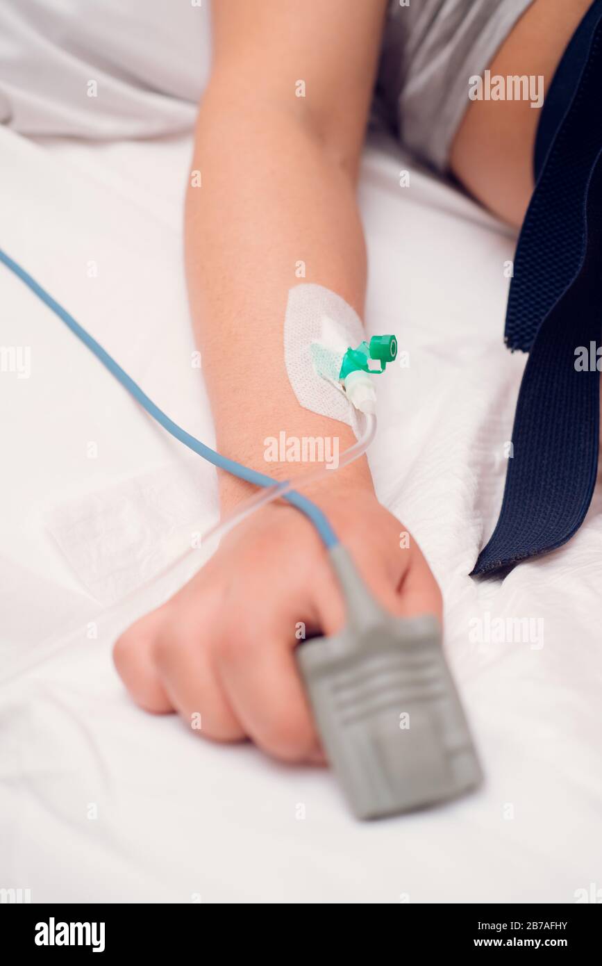 Iv fluid, intravenous with sodium chloride applying to the patient hand in the hospital. Stock Photo