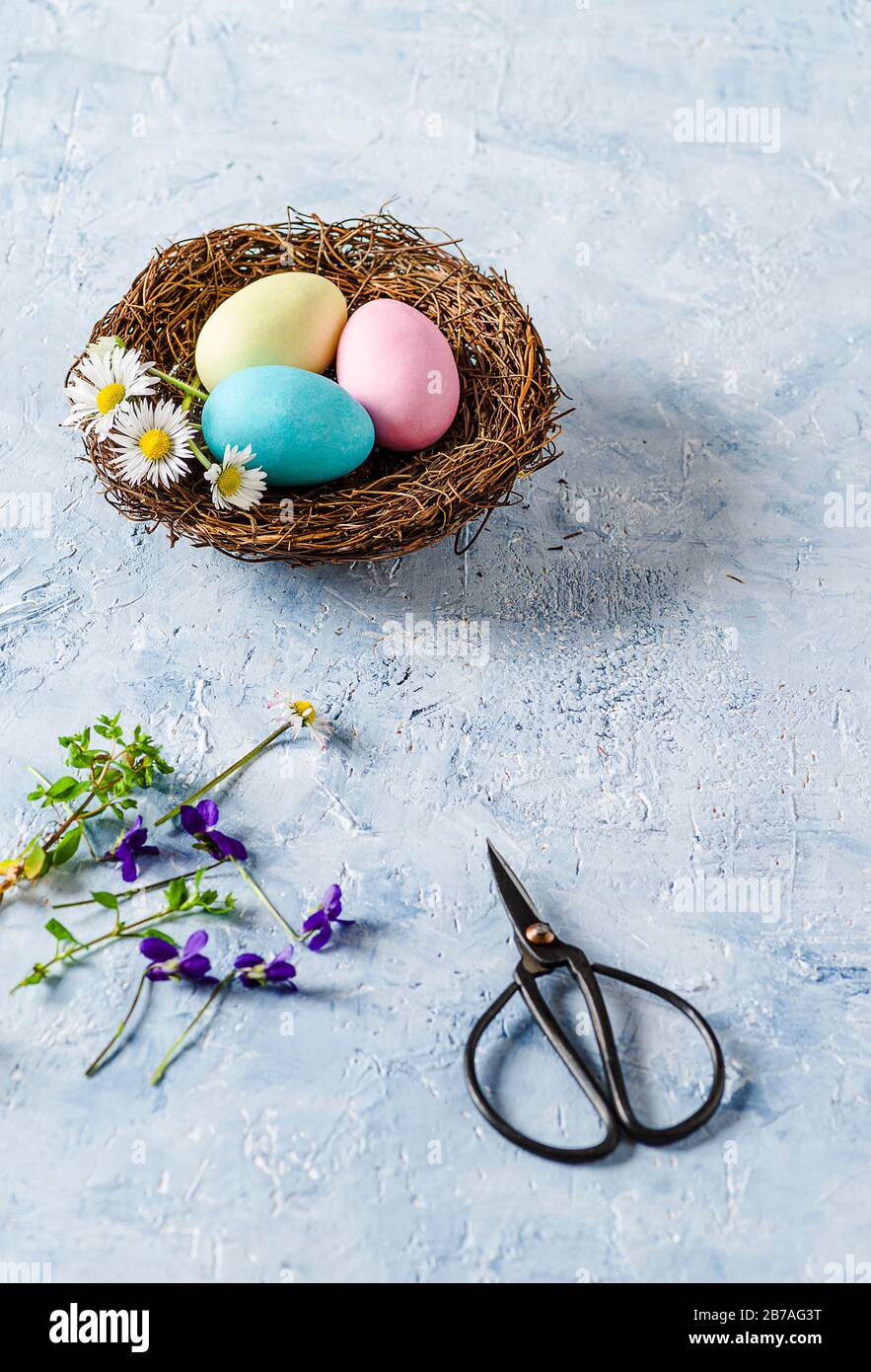 Three Easter eggs on delicate blue background Stock Photo