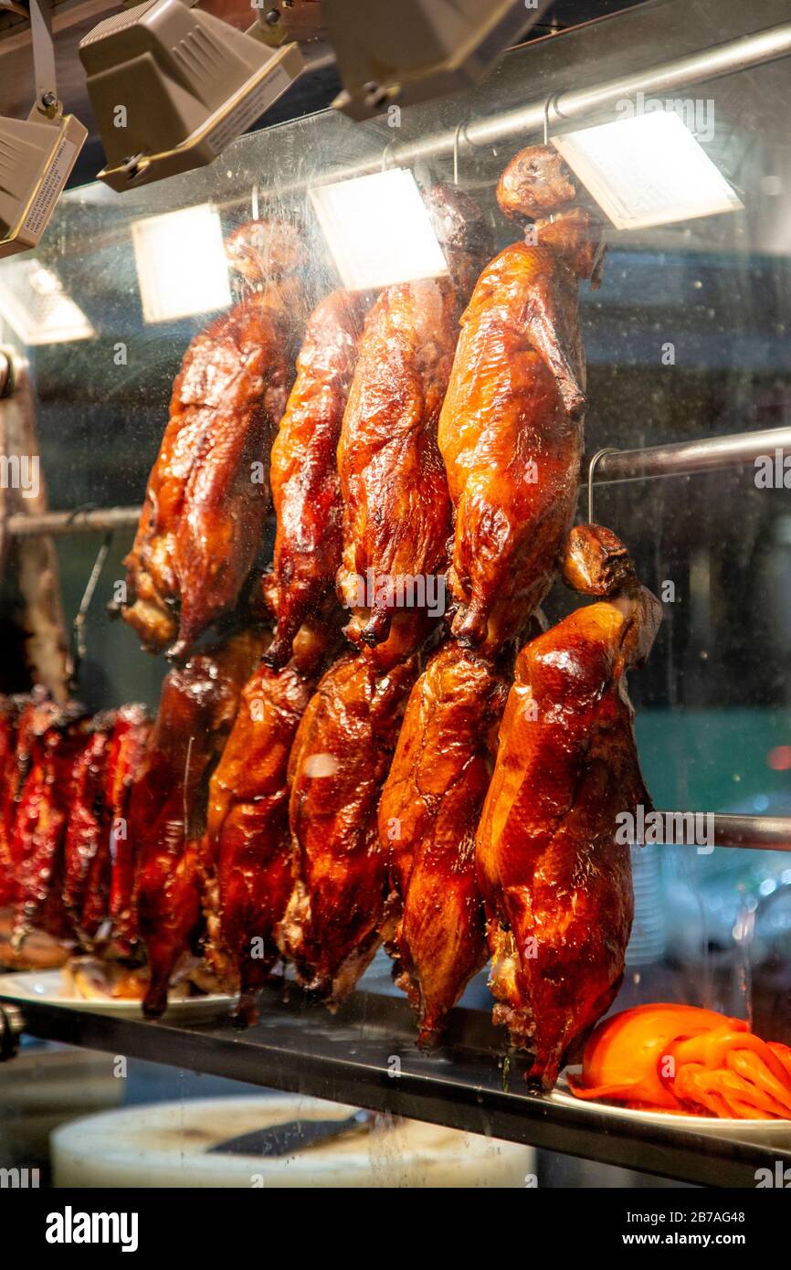 Delicious crispy roast ducks hanging in the display window of Wan Chai Corner restaurant in Chinatown, London, UK Stock Photo