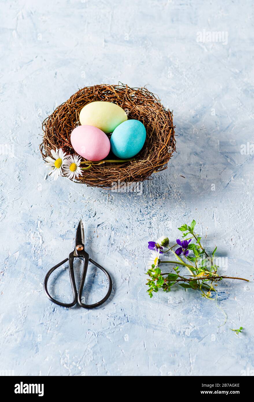 Three Easter eggs on delicate blue background Stock Photo