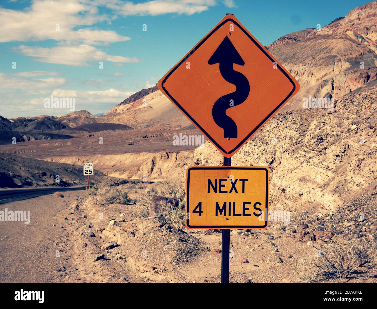 Many curves yellow road sign in the death valley scenic road Stock Photo