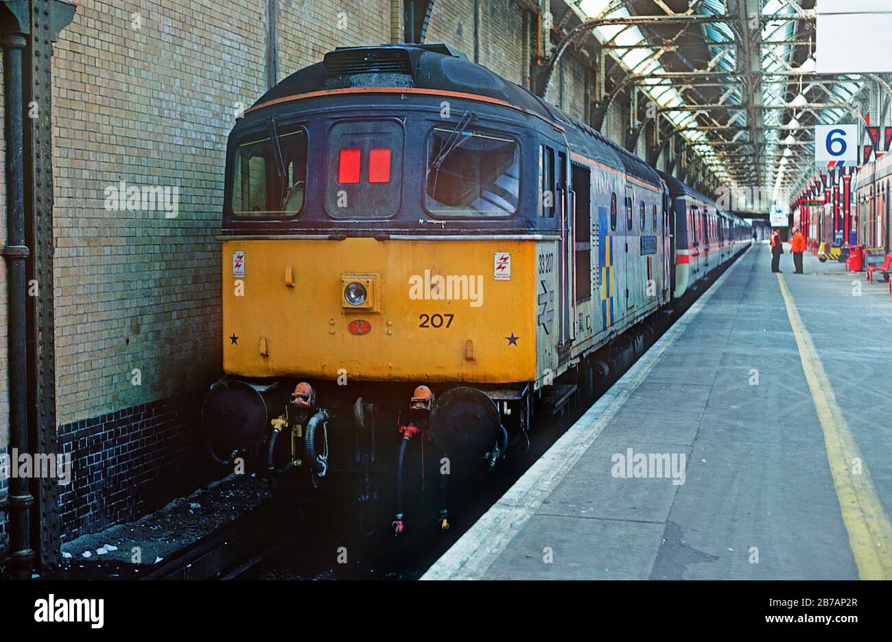 A class 33 diesel locomotive number 33207 prepares to shut the InterCity stock in order to release the class 47 that had arrived earlier at the now closed Dover Western Docks station. 5th September 1992. Stock Photo