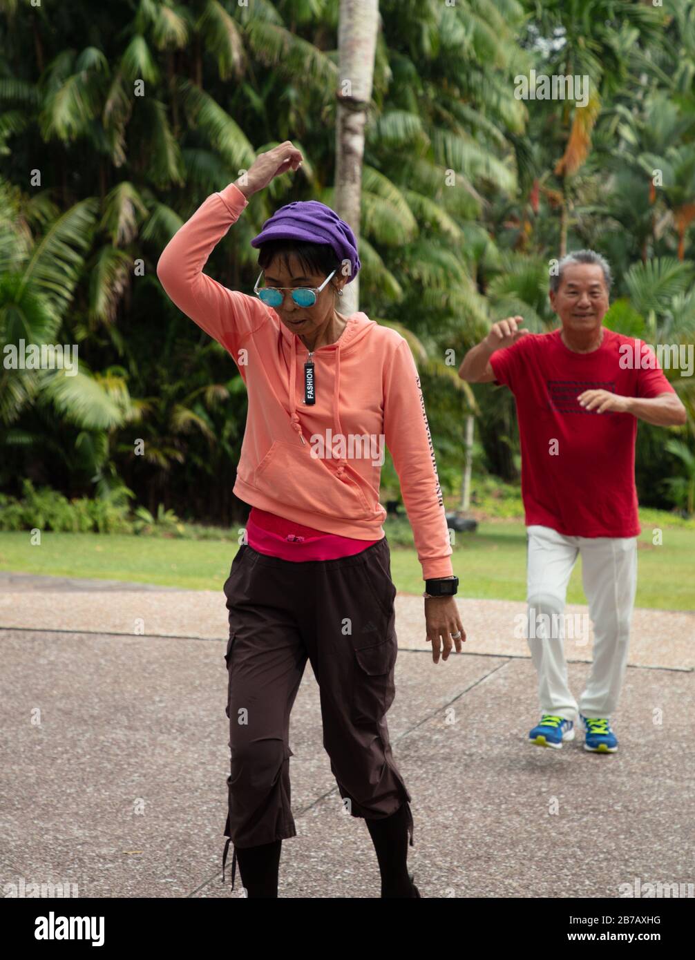 Group of senior citizens seen in a dance exercise class in Singapore Botanic Gardens. Stock Photo
