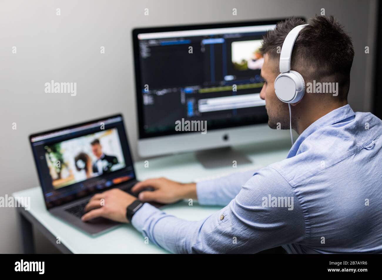 back view of video editor using computer Stock Photo