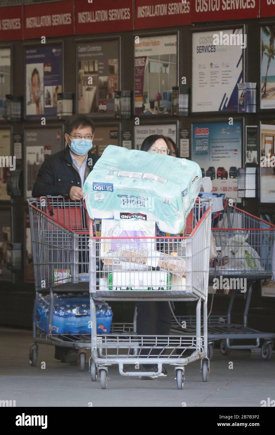 Vancouver, Canada. 14th Mar, 2020. Shoppers push carts loaded with goods outside a Costco warehouse in Vancouver, Canada, on March 14, 2020. More than 200 cases of COVID-19 have been reported in Canada. Credit: Liang Sen/Xinhua/Alamy Live News Stock Photo
