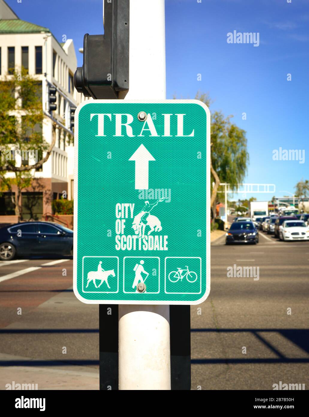 A City of Scottsdale bronco rider logo on green and white Trail directional sign for horseback trail, hiking trail and cycling trail in Scottsdale, AZ Stock Photo