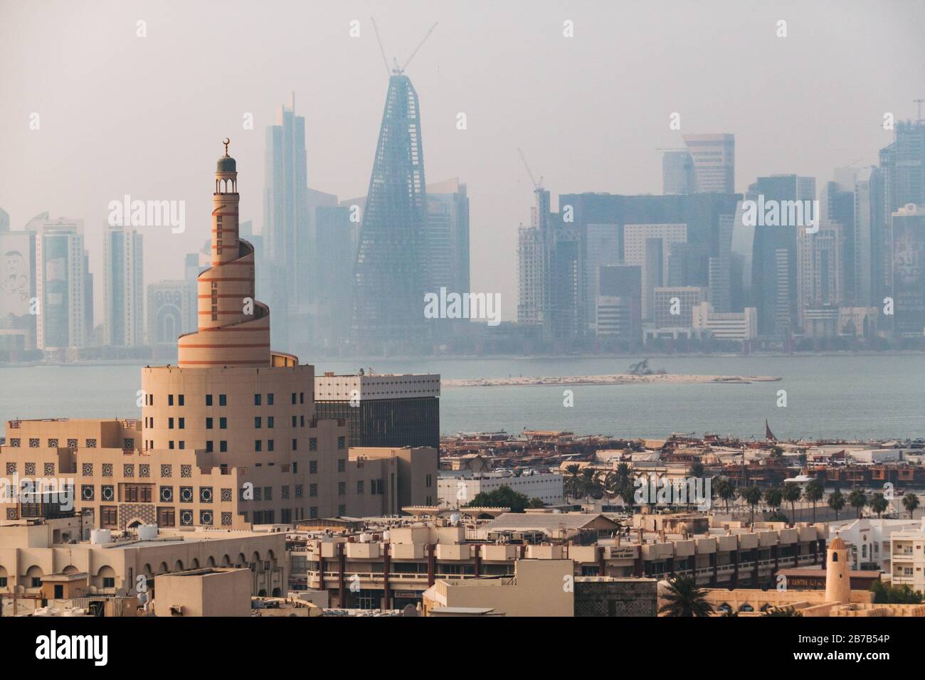 The famous Spiral Mosque in Doha, Qatar - a replica of the Great Mosque of Al-Mutawwakil in Samarra in Iraq. The city skyline can be seen behind Stock Photo