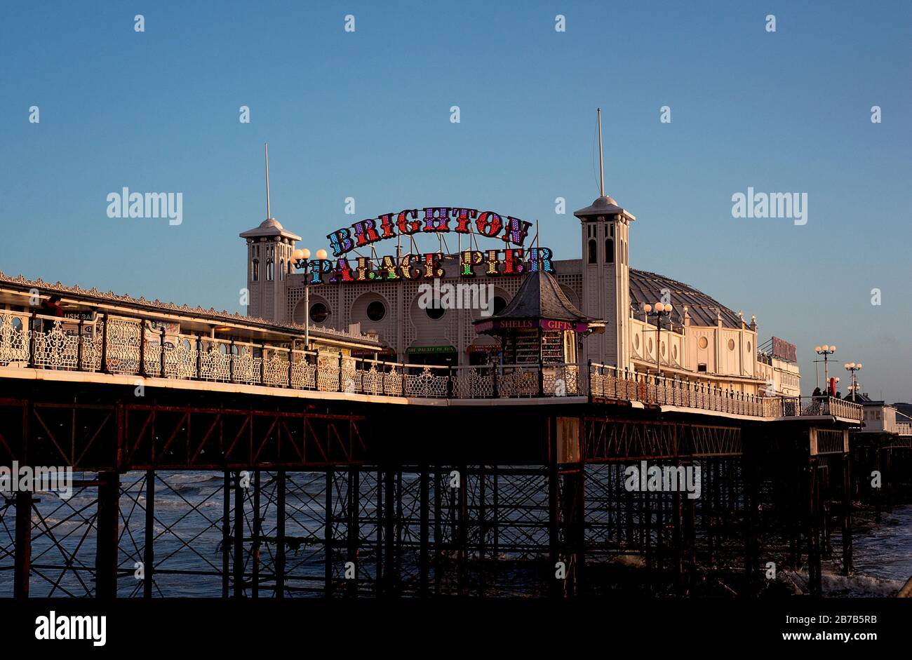 Brighton and Hove, Sussex, UK. Brighton Palace Pier on a sunny day. The famous seaside pier is one of the U.K.'s most popular tourist attractions. Stock Photo